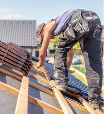 Experienced roofing specialist installing tiles with precision craftsmanship
